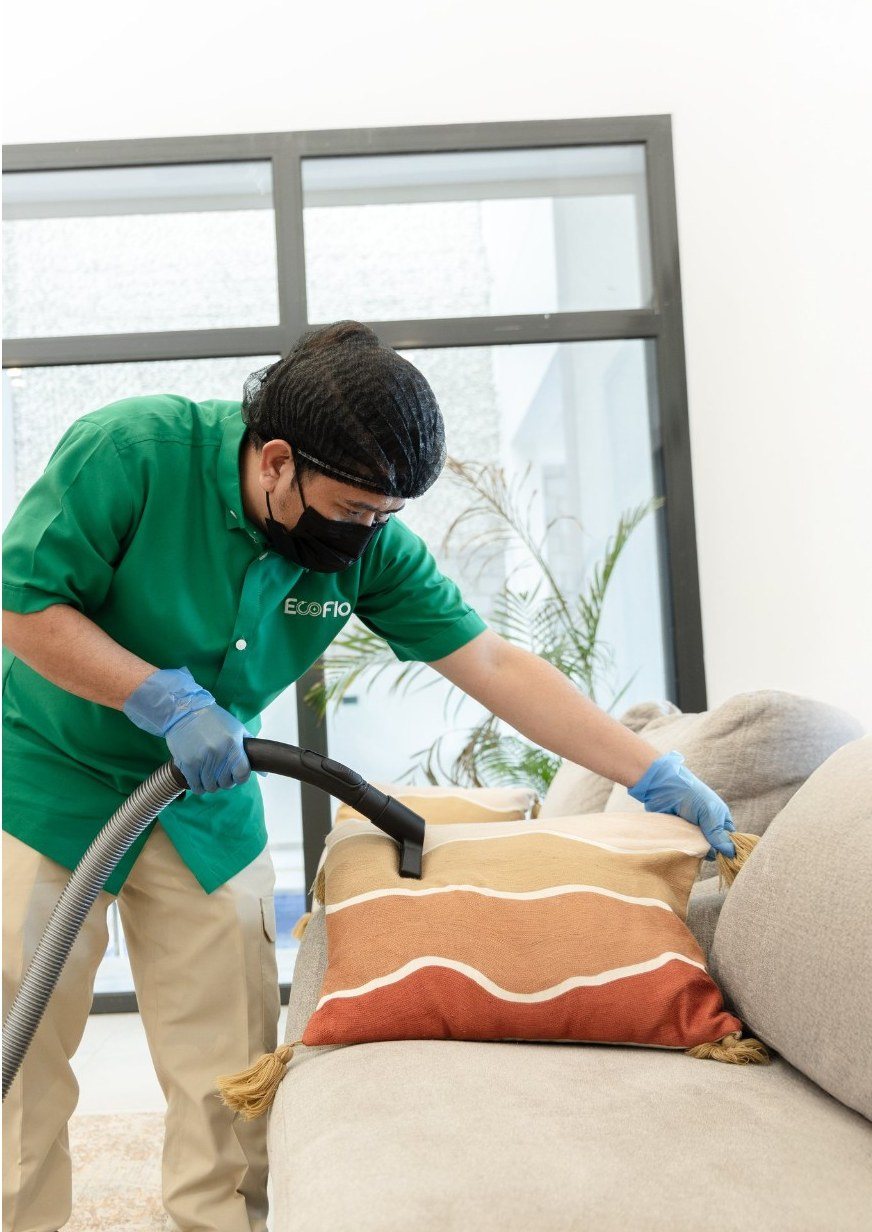 EcoFlo specialist cleaning a sofa with extraction equipment